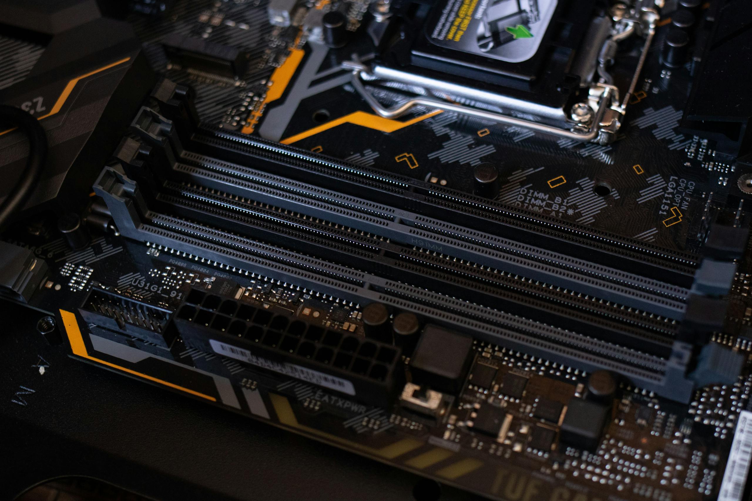 Detailed view of a computer motherboard showcasing RAM slots and electronic components.