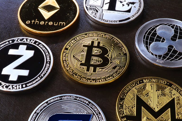 Detailed view of assorted cryptocurrency coins including Bitcoin, Ethereum, and Ripple.